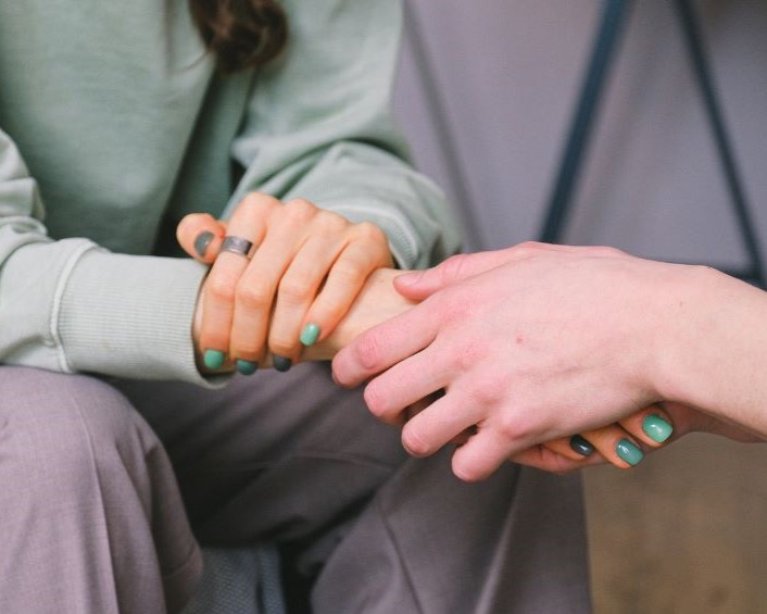 Two people holding hands