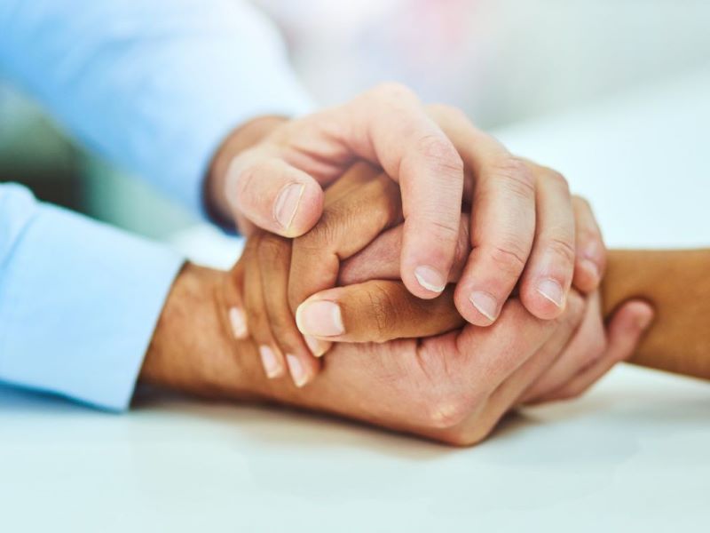 Two people holding hands