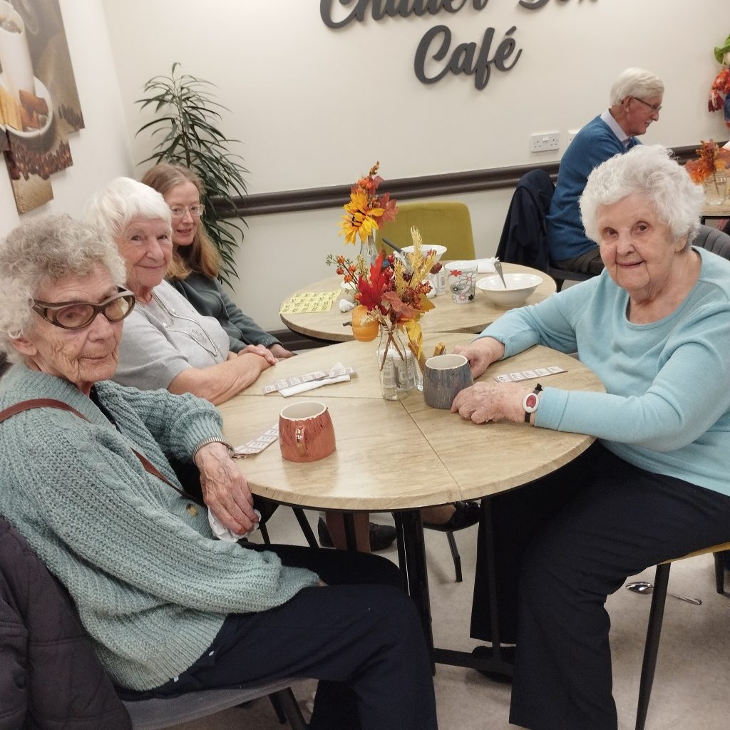 Image shows three ladies smiling and enjoying harvest soup.