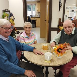 Image shows a small group of people enjoying harvest soup.